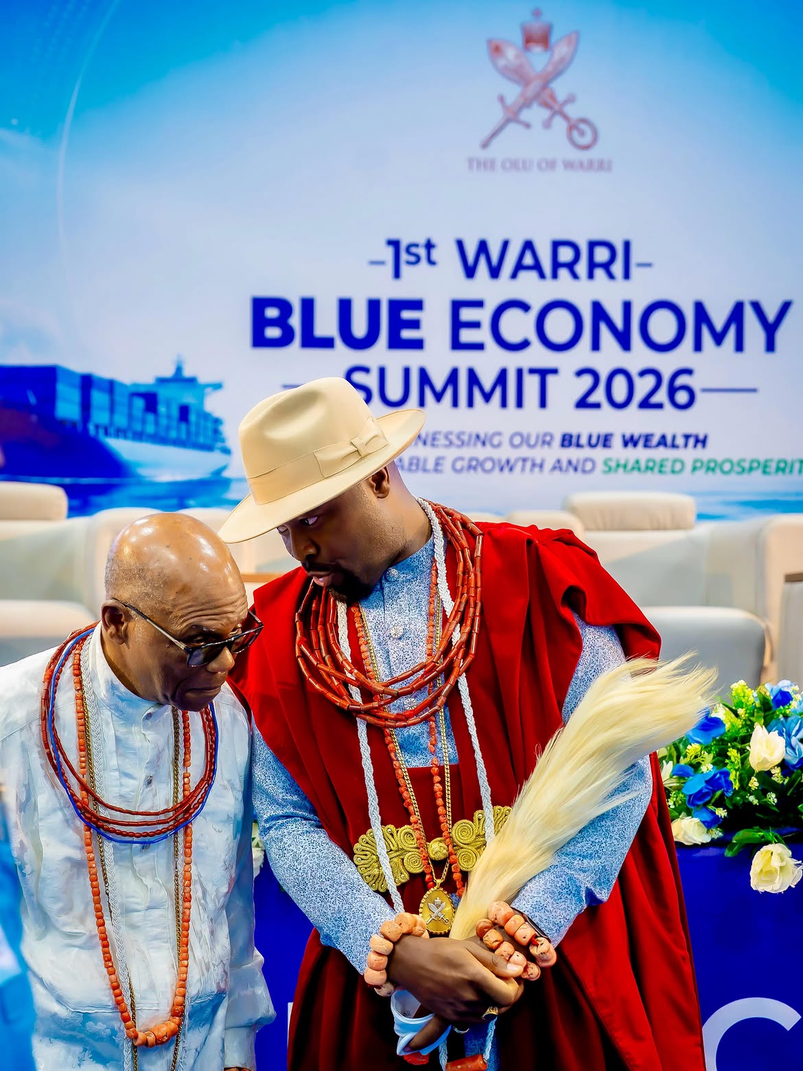 His Majesty Ogiame Atuwatse III before the summit backdrop