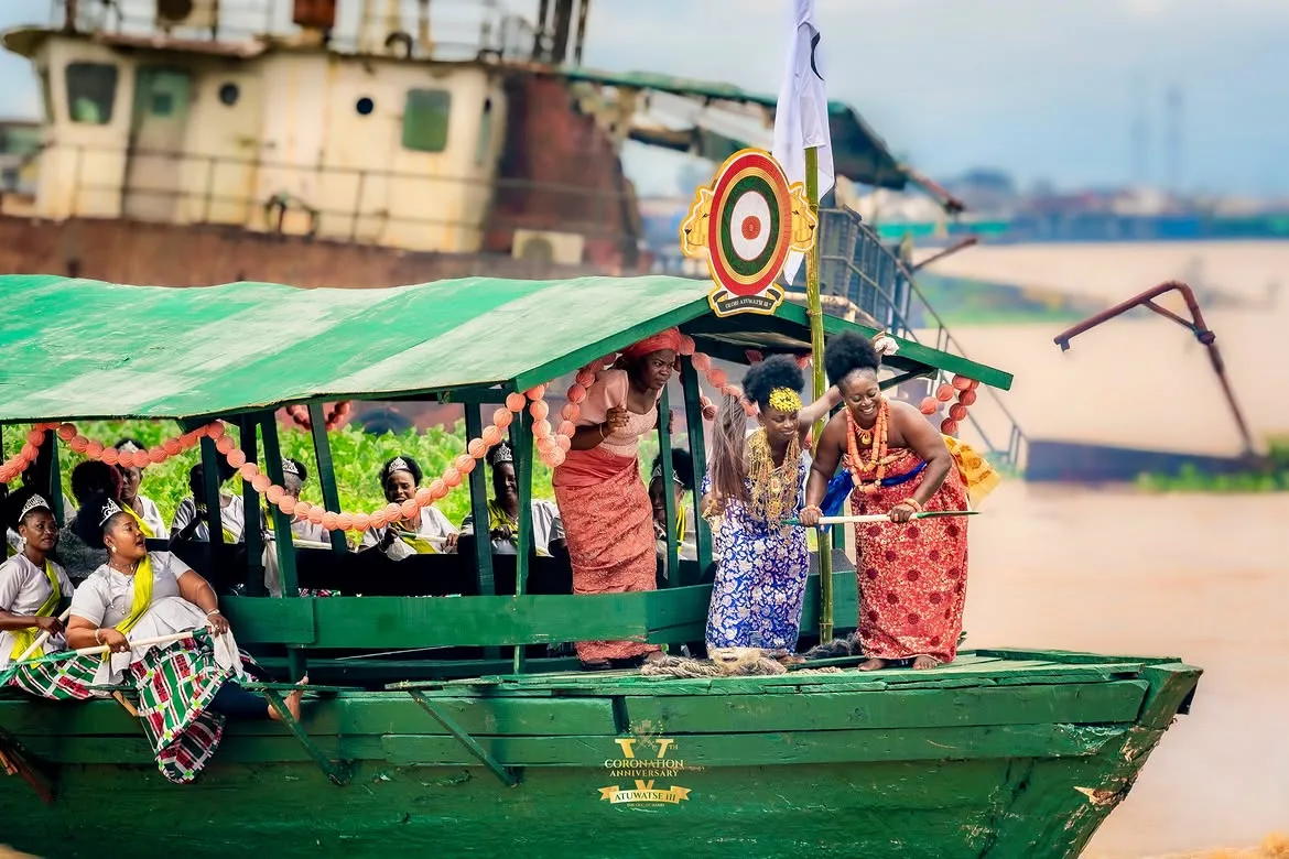 Community performers aboard a green regatta boat